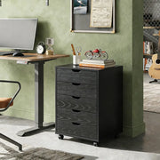 Black Bedside Table with Drawers (5-Tier) next to a desk in a modern workspace.
