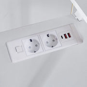 Close-up of built-in AC power outlets and USB charging ports on desktop