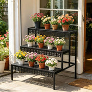 Black metal plant shelf positioned beside a patio door with colourful flower pots