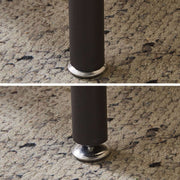 Close-up of the adjustable leg of the Industrial 2-Tier Side Table CT-331 on a carpeted floor.
