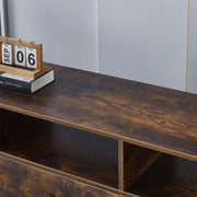 Top view of an industrial TV stand showcasing rustic wood finish with a calendar and books for stylish decor.