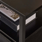 Close-up of a TV stand with charging station showing books on a shelf, highlighting functional design.