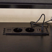 Modern computer desk power outlets for convenient charging and easy access to electronics.