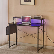 Modern computer desk with power outlets, featuring a laptop, coffee cup, and stylish design for home office.