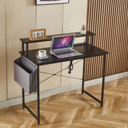 Modern computer desk with power outlets, laptop, coffee cup, and side storage for home office.