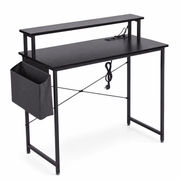 Modern computer desk featuring power outlets and an attached storage bag for added convenience.