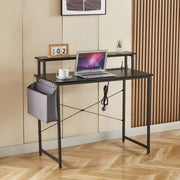 Modern computer desk with power outlets, laptop, and storage for an organized workspace.