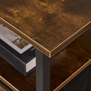 Close-up of a stylish TV stand with charging station, featuring a wooden surface and metal frame.