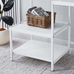 Close-up of white multi-tier storage shelves for computer desk organization