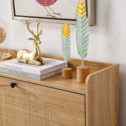 Rattan Flip-Top Shoe Cabinet showing a stylish top surface decorated with a gold deer figurine and decorative leaves.