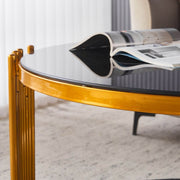 Round Glass Coffee Table with gold geometric frame and black tempered glass surface, perfect for modern decor.