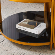Round Glass Coffee Table showcasing a geometric gold frame and a black glass surface with a book on it.