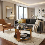 Round Glass Coffee Table in a modern living room with clean lines and a gold geometric frame.