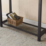 Close-up of a rustic console table showcasing a woven basket and stylish books on the lower shelf.
