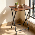 Rustic folding TV tray table with succulent plant and teapot, ideal for maximizing small spaces.