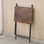 Rustic folding TV tray table stored flat against the wall, showcasing its compact design and wooden finish.