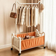 Steel Clothing Rack with Shelves & Wheels displaying hanging clothes and storage for toys and bags.