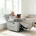 Senior man enjoying a book in a Swivel Rocker Recliner with a tray table, providing ultimate comfort and relaxation.