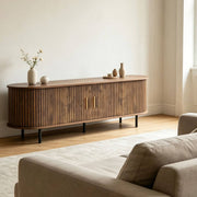Tambour door TV stand supporting a large flat screen TV in a contemporary home