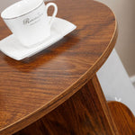 Top surface of 2-tier rotating bookshelf displaying small potted plant and coffee cup