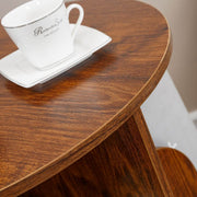 Top surface of 2-tier rotating bookshelf displaying small potted plant and coffee cup